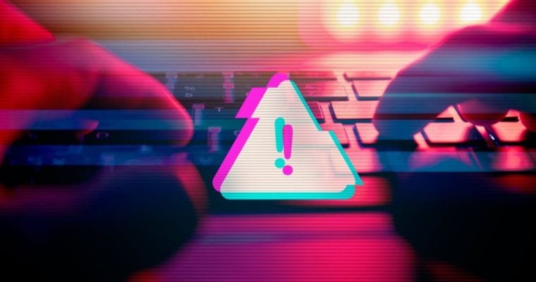 Triangle with Exclamation Mark Represents Digital Scam Warning with Hands Touching Keyboard