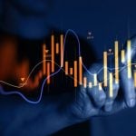 Man Points to A Section of A Digital Graph that Rises and Falls