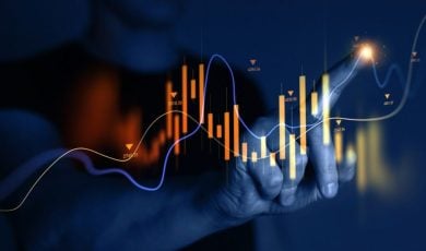 Man Points to A Section of A Digital Graph that Rises and Falls