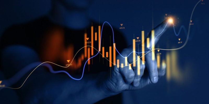 Man Points to A Section of A Digital Graph that Rises and Falls