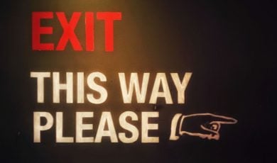 Red and White Exit Sign Reads 