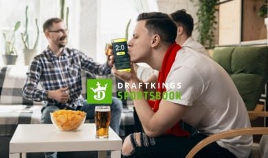 Friends Celebrate Sports Win, Man Kisses Cell Phone with DraftKings Logo