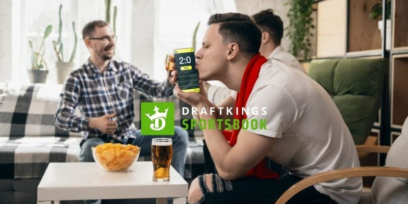 Friends Celebrate Sports Win, Man Kisses Cell Phone with DraftKings Logo