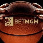 BetMGM Logo Over Close Up Image of Man Holding Basketball