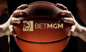 BetMGM Logo Over Close Up Image of Man Holding Basketball