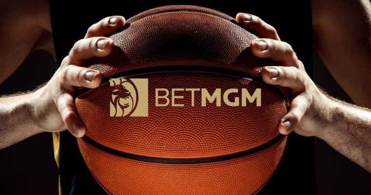BetMGM Logo Over Close Up Image of Man Holding Basketball