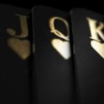 Black Playing Cards Display Royal Flush in Gold Ink