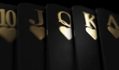 Black Playing Cards Display Royal Flush in Gold Ink