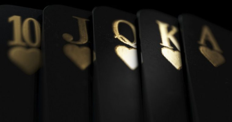 Black Playing Cards Display Royal Flush in Gold Ink