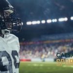 Caesars Sportsbook Logo Over Image of American Football Player with Focused Gaze Inside Stadium