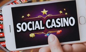 Close Up of Mobile Phone Reading "Social Casino" Held in Hand Sideways