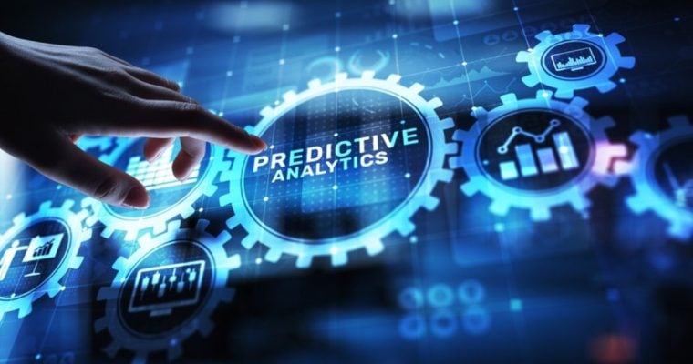 Digital Blue Gear Cogs Connected to Center Cog Reading "Predictive Analytics"