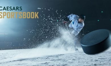 Caesars Sportsbook Logo Over Image of Hockey Player Hitting Puck While Spraying Ice Up