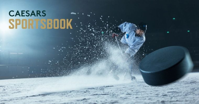 Caesars Sportsbook Logo Over Image of Hockey Player Hitting Puck While Spraying Ice Up