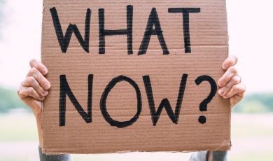 Cardboard Sign Reads 