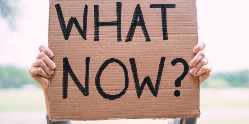 Cardboard Sign Reads 