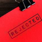 Close Up of Red Document Stamped With the Word 