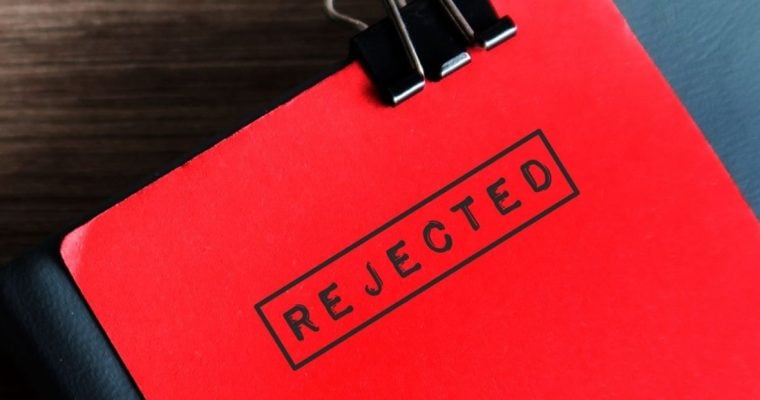 Close Up of Red Document Stamped With the Word "Rejected" In Black