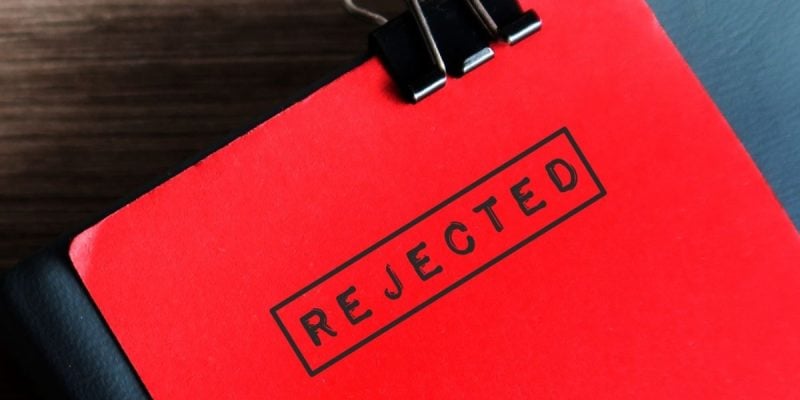 Close Up of Red Document Stamped With the Word 