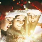 Christmas Gift Filled with Sparkling Light Opened by Three Young Ladies