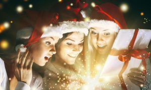 Christmas Gift Filled with Sparkling Light Opened by Three Young Ladies