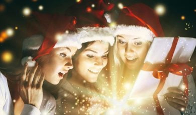 Christmas Gift Filled with Sparkling Light Opened by Three Young Ladies