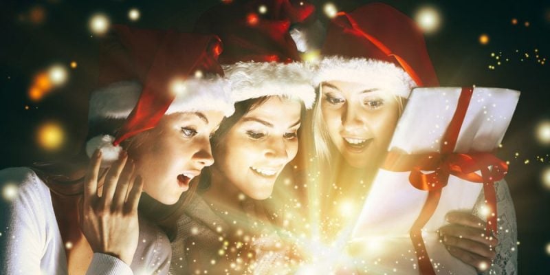 Christmas Gift Filled with Sparkling Light Opened by Three Young Ladies