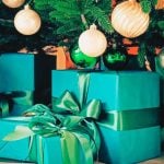Close Up of Green Gifts Under Decorated Christmas Tree