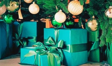 Close Up of Green Gifts Under Decorated Christmas Tree