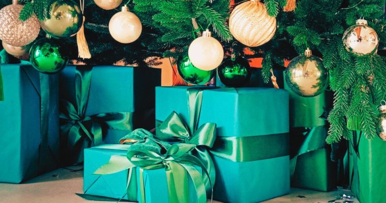 Close Up of Green Gifts Under Decorated Christmas Tree