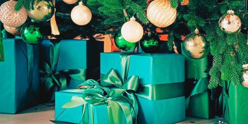 Close Up of Green Gifts Under Decorated Christmas Tree
