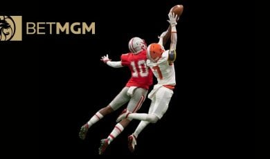 BetMGM Logo Over Image of Two Football Players in Mid-Air Jump to Catch Football