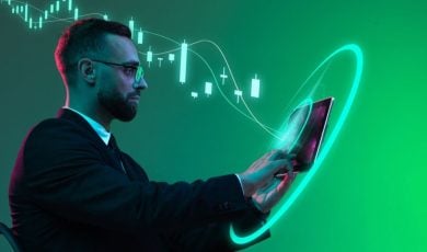 Digital Market Trends Graph Behind Business Man Using iPad