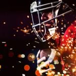 Red & Yellow Fireworks Burst Beneath American Football Player