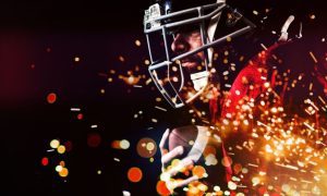 Red & Yellow Fireworks Burst Beneath American Football Player