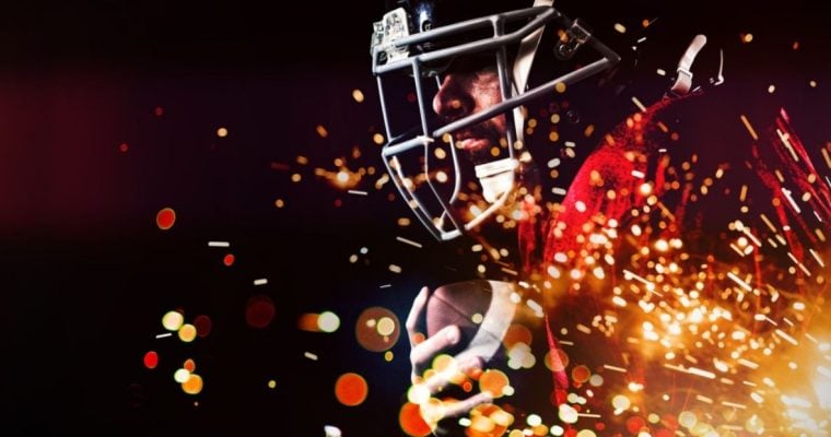 Red & Yellow Fireworks Burst Beneath American Football Player