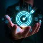 Digital Target with Arrow Held By Business Man on Dark Background