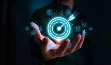 Digital Target with Arrow Held By Business Man on Dark Background