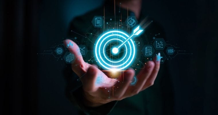 Digital Target with Arrow Held By Business Man on Dark Background