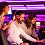 Two companies have partnered to stream online casino content onto slot machines at land-based casinos.