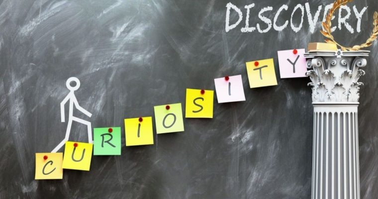 Post-It Notes Spell Out Curiosity As Stick Figure Walks Up Towards Discovery All on Chalkboard