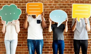 Anonymous People Hide Faces Behind Oversized Colorful Paper Speech Bubbles