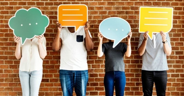 Anonymous People Hide Faces Behind Oversized Colorful Paper Speech Bubbles