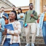 Group of Male and Female University Students Walk Down Campus Steps