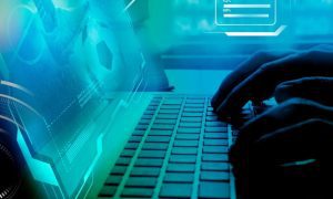 Blue-toned Image of Soccer Game on Laptop with Man's Hands