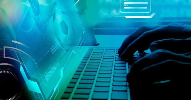 Blue-toned Image of Soccer Game on Laptop with Man's Hands