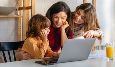 Young Children Use Laptop With Mother's Guidance