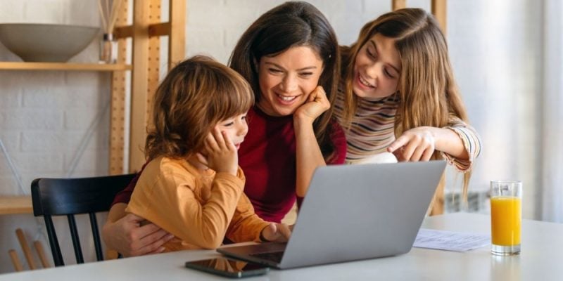 Young Children Use Laptop With Mother's Guidance
