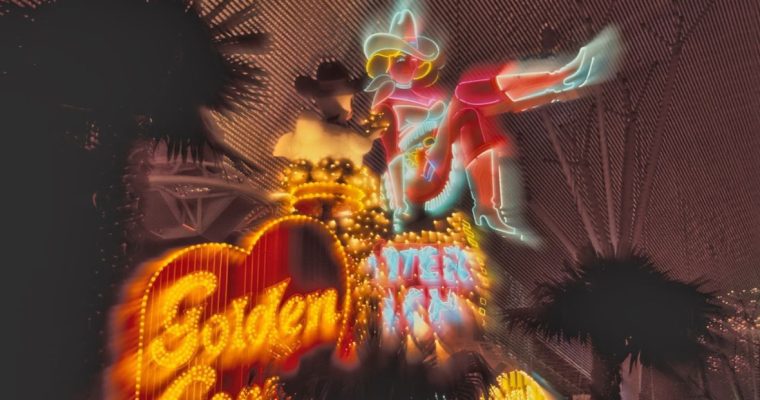 Downtown Las Vegas Neon Sign Lit Up at Night with Palm Trees Background