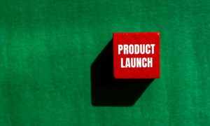 Red Cube Reads "Product Launch" in White Font on Green Background